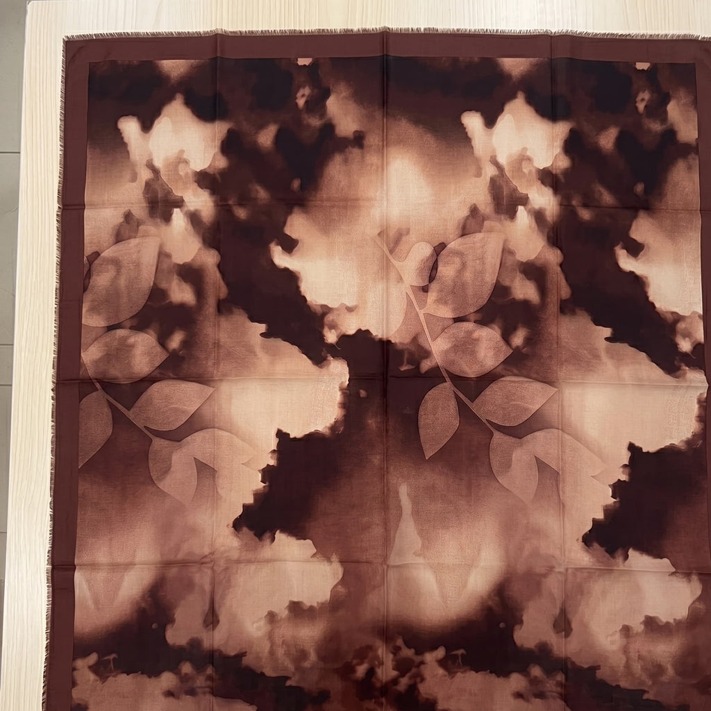 Floral patterned fabric with a brown and beige color scheme on a white background