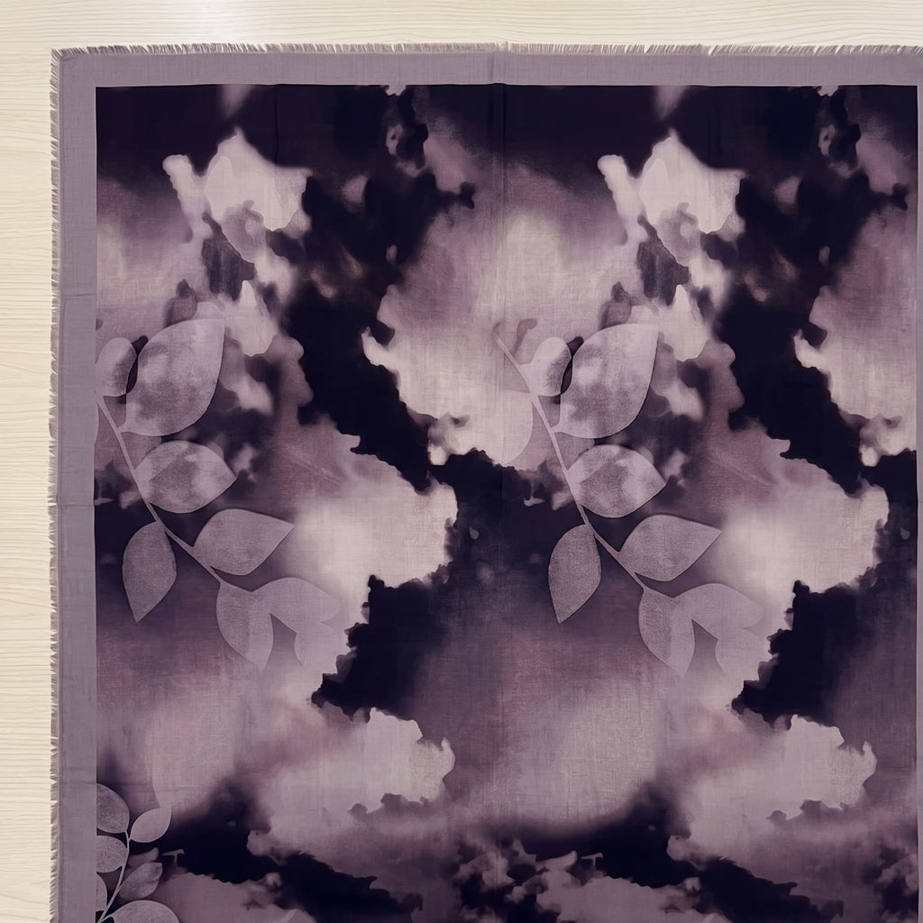 Floral patterned fabric with a dark and light color scheme on a plain background