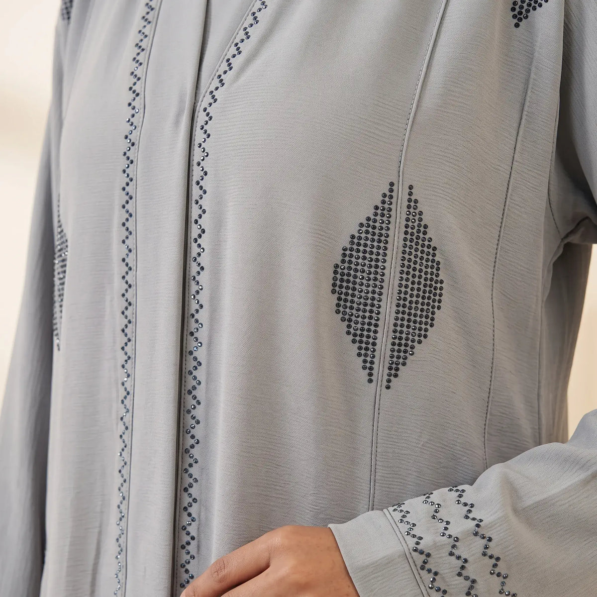 Diamond Bead & Zigzag Pleat Front Open Abaya in Blush Pink – seated full length
